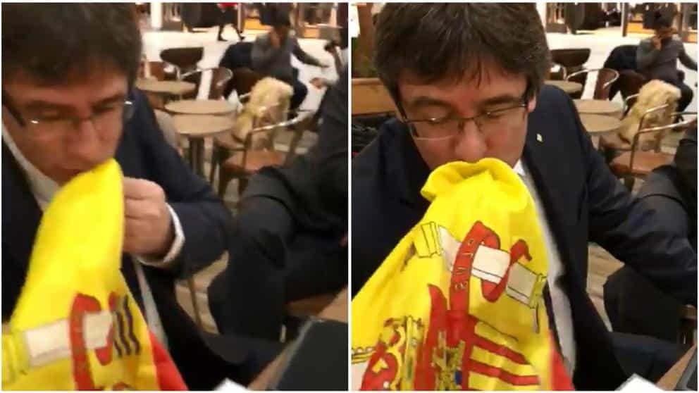 Puigdemont dio dos besos a la bandera de España ante el hombre que le increpaba